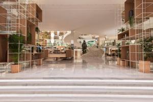 a lobby with stairs and plants in a building at Meliá Palma Marina in Palma de Mallorca
