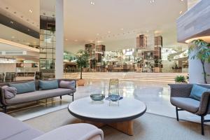 a lobby with couches and a table in a building at Meliá Palma Marina in Palma de Mallorca