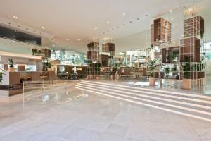 a lobby of a building with stairs and tables at Meliá Palma Marina in Palma de Mallorca +130 photos