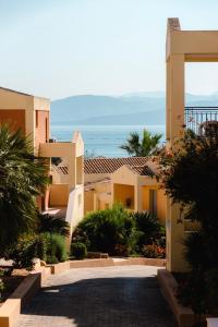a view of a building with the ocean in the background at Olympion Village in Kavos