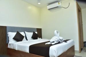 a stuffed animal is sitting on a bed at Hotel safal exotica in Puri