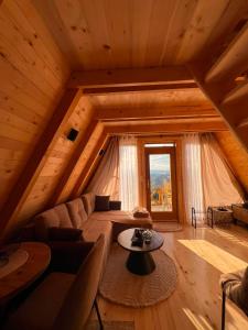 a living room with a couch and a table at Komovi Luxury Sunset in Andrijevica
