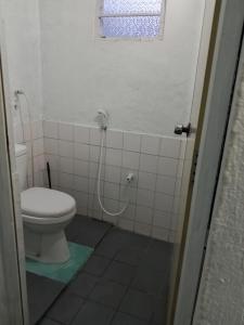 a bathroom with a toilet and a shower at The Home in Weligama
