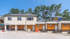 a building with a parking lot in front of it at Samcheok ara Pension in Samcheok