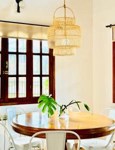 a dining room with a wooden table and white chairs at Las Margaritas in Ushuaia