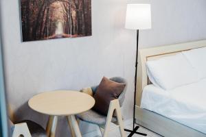 a room with a bed and a table and a chair at Samcheok The Ggeullim Pension in Samcheok