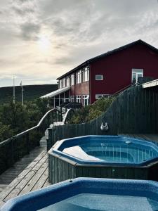 ein Whirlpool auf einer Holzterrasse neben einem Gebäude in der Unterkunft Hotel Glymur in Leirá