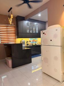a kitchen with a white refrigerator and a counter at Casa Permai Temerloh in Temerloh +12 photos