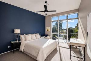 a bedroom with a large bed and a blue wall at Murramarang Haven in Bawley Point