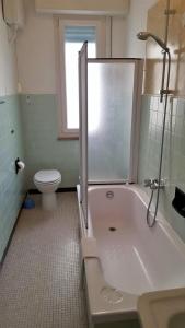 a bathroom with a shower and a tub and a toilet at Hotel Miramare in Savona