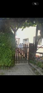a wooden fence with a gate in front of a building at Studio Tatarskie,Parking! in Przemyśl