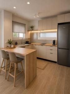 a kitchen with a wooden table and a refrigerator at Spiti mou - 2bd House in Mastihari