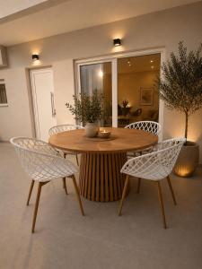 a wooden table with two chairs and a table with a bowl at Spiti mou - 2bd House in Mastihari