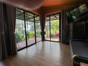 a living room with sliding glass doors and a porch at Pine Hill Villa 3 Vì in Ba Vì