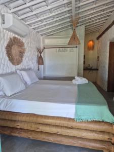 a bedroom with a large white bed in a room at Villa Água Viva in Itarema