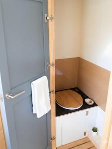 a small bathroom with a wooden toilet in it at Tinyhaus in Dornburg +3 photos