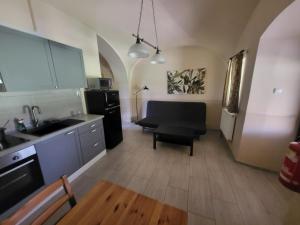 a kitchen with a sink and a black refrigerator at ubytovaní na statku 