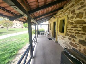 a porch of a stone building with a table at ubytovaní na statku 