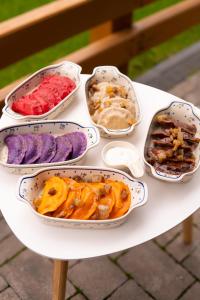 a table with four bowls of different colored food at Плай in Khmelnytskyi +15 photos