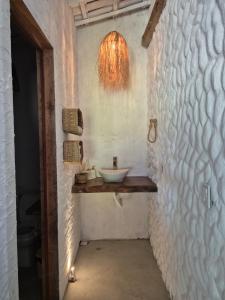 a bathroom with a sink on a wall at Villa Água Viva in Itarema