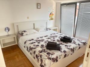 a bedroom with a bed with two bags on it at Acacia Hills D8 in Herceg Novi in Herceg-Novi +17 photos