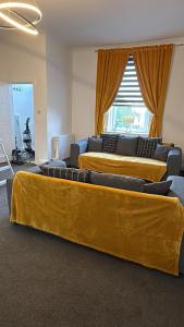 three beds in a room with yellow curtains at The M Rooms at 158 in Shotts Station