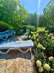a bench in a garden with flowers and plants at Эко отель Прованс Одесса in Odesa