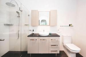 a bathroom with a sink and a toilet and a shower at Eurunderee House in Eurunderee +106 photos