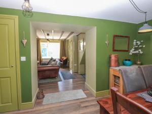 a living room with green walls and a couch at Banklands in Barnard Castle