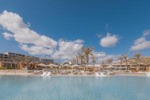 a pool at a resort with chairs and umbrellas at Park Hyatt Cabo Del Sol in Cabo San Lucas