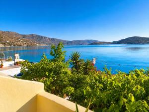 a view of a body of water from a balcony at Christina Boutique Studios Elounda in Elounda