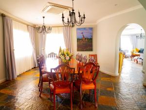 a dining room with a table and chairs at Kasimba Boutique Hotel in Gaborone