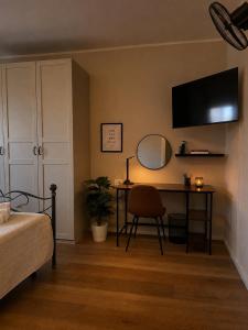a bedroom with a desk and a mirror and a bed at Guest House 36 private parking in Orbetello