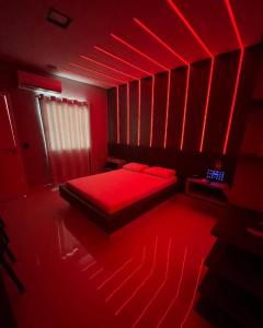 a red bedroom with a bed with red lighting at Luxus Motel Caldas do Jorro in Tucano