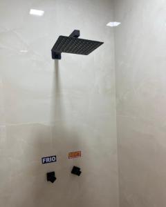 a shelf on the wall of a room at Luxus Motel Caldas do Jorro in Tucano +3 photos