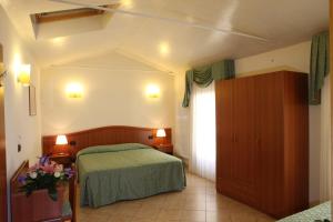 a hotel room with a bed and a window at Albergo Alla Campana in Dolo