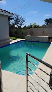 a swimming pool with blue water in a house at Brooke Paradise in Bulawayo