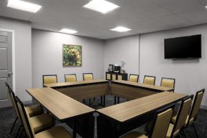 a conference room with a table and chairs and a tv at Hampton Inn Terre Haute in Terre Haute