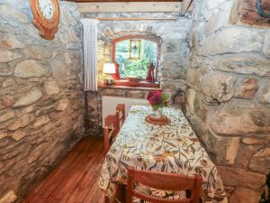 a dining room with a table and a mirror at Penfeidr Newydd in Newport