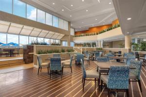 a dining area with tables and chairs in a restaurant at DoubleTree Suites by Hilton Melbourne Beach Oceanfront in Melbourne