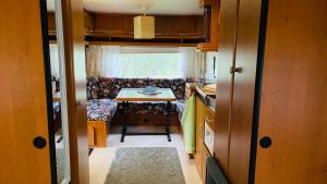 a small kitchen with a table and a small table and a tableablish at Caravan at the Cottage House in Ertenvåg +30 photos
