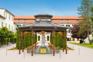 a gazebo with a fountain in front of a building at Hotel Radin, Radenci Spa Resort - Sava Hotels & Resorts in Radenci