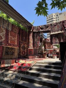 a pile of carpets on the side of a building at White Hotel in Yerevan