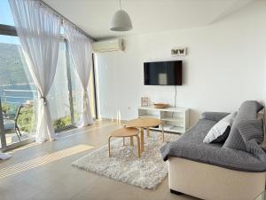 a living room with a couch and a table at Acacia Hills D8 in Herceg Novi in Herceg-Novi