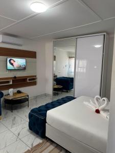 a hotel room with a bed and a living room at Malrose guesthouse Tours And safaris Windhoek Namibia Airport Shuttle services available in Windhoek