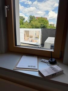 a window with a book and a lamp on a desk at Wohnen an der Mühlenwiese in Bad Sobernheim