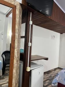 a loft bed in a room with a desk at Hospedaria Gaúcha in Penha