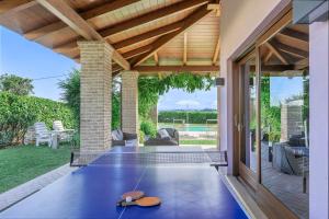 an outdoor patio with a table with a pair of shoes on it at Villa Sara in San Costanzo