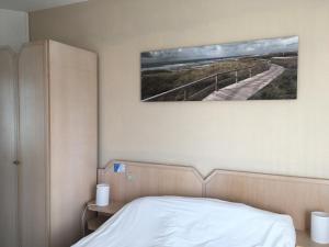 Кровать или кровати в номере Hotel La Terrasse