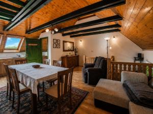 a living room with a table and a couch at Nánaháza in Alsónána